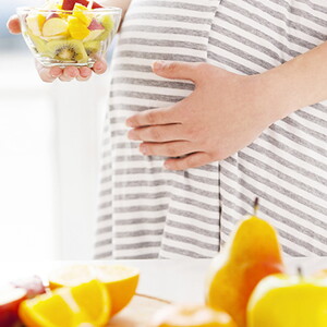 Pregnant women eating fruit salad Pregnant women eating fruit salad